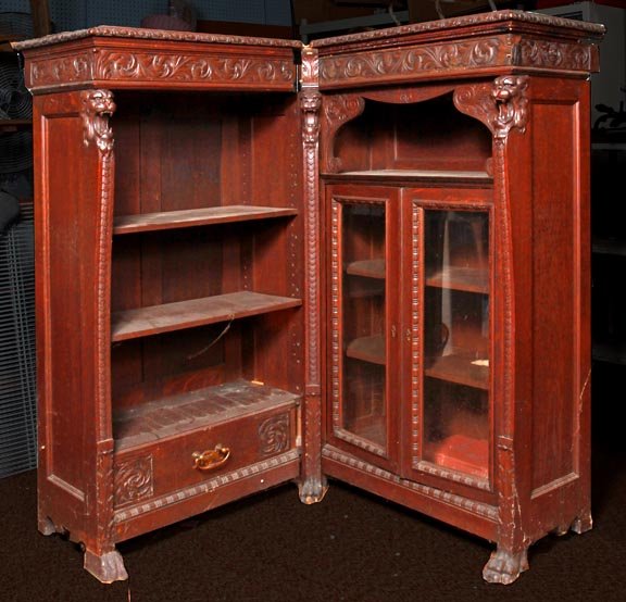 Carved lion oak corner bookcase, late 19th C., prime co