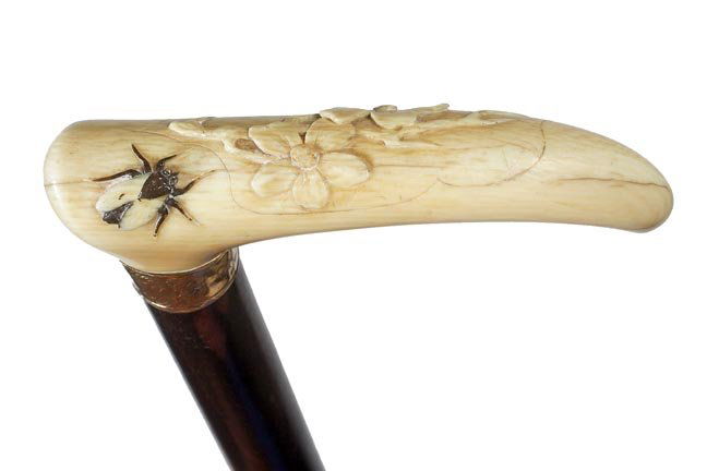 50. Ivory Fly Dress Cane-Ca. 1890-An unusual carved han: 50. Ivory Fly Dress Cane-Ca. 1890-An unusual carved handle with flowers and a India inked house fly, ornate gold-filled collar, exotic wood shaft and a horn ferrule-H. 3 ¼” x 1 ½”, O.L. 36”-