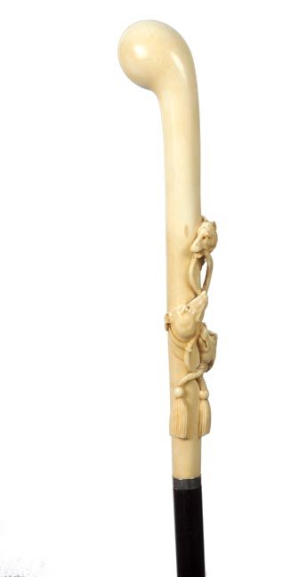 57. Ivory Wolf and Dog Cane-Ca. 1900-An unusual carved : 57. Ivory Wolf and Dog Cane-Ca. 1900-An unusual carved handle in high relief with what appears to be a wolf and two hounds, signed sterling collar, ebony shaft and an ivory ferrule-H. 9” x 2”, O.L