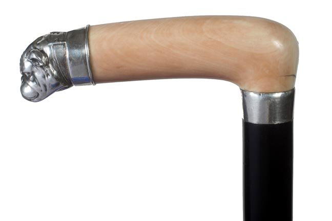 67. Ivory and Silver Dog Cane-Ca. 1900-A cast silver me: 67. Ivory and Silver Dog Cane-Ca. 1900-A cast silver metal dog with ruby eyes is the end cap of a smooth ivory handle, silver metal collar, thick ebony shaft and a metal ferrule-H. 4 ¾” x 1 3/8”,