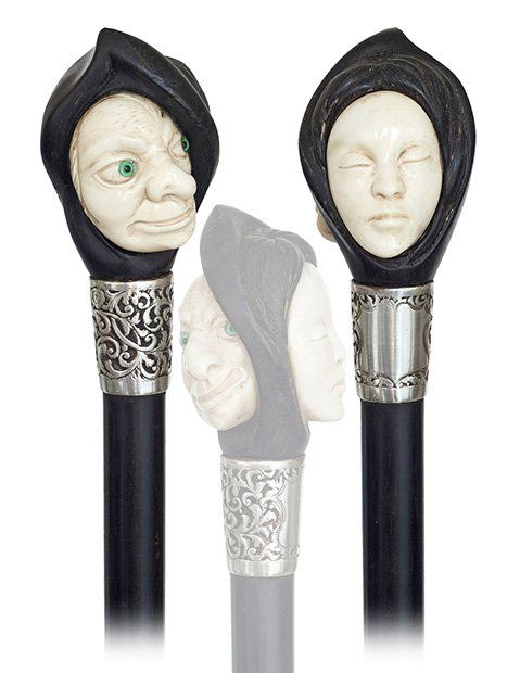 79. Ebony and Ivory Figural cane-Ca. 1890-Ebony and ivo: 79. Ebony and Ivory Figural cane-Ca. 1890-Ebony and ivory knob with the face of a man against the one of a woman, well chased silver collar, ebony shaft and a horn ferrule. Delicate carving in the tra