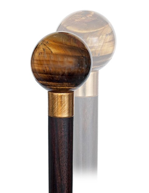 122. Tiger Eye Dress Cane-19th Century-The balls handle: 122. Tiger Eye Dress Cane-19th Century-The balls handle with brown-gold petrified wood structure, rosewood shaft with a gilt collar and a horn ferrule. French.-H. 1 ¾”x 1 ¾”, O.L. 38 ¾”-