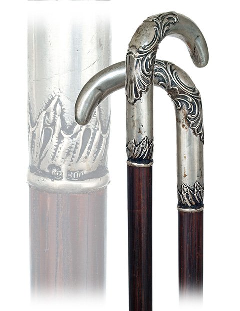 157. Feminine Dress Cane-Ca. 1890-Small silver crutch h: 157. Feminine Dress Cane-Ca. 1890-Small silver crutch handle with a pointed nose and hand chased Baroque scrolls, coco palm wood shaft with a brass ferrule. The 800 and half moon with crown silver hal