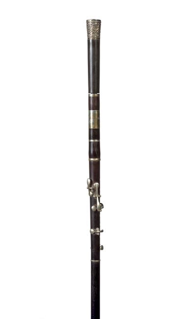 172. Piccolo System Cane-Ca. 1925-Ornate silver handle,: 172. Piccolo System Cane-Ca. 1925-Ornate silver handle, 8 holed instrument with 5 keys, shaft separates into 5 sections, ebony shaft and a long ferrule-O.L. 36”-