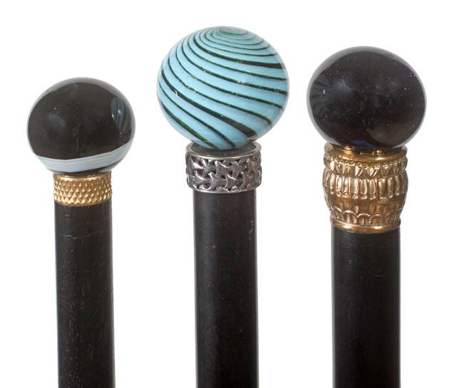 179. Collection of Glass Knob Canes-20th Century-A grou: 179. Collection of Glass Knob Canes-20th Century-A group of three mint glass sphere canes with ornate collars, ebony shafts and metal ferrules, largest sphere is1 ¾” x 1 ¾”, average length is 36