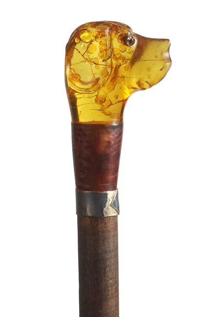 243. Art Deco Lucite Dog Cane-Ca. 1925-A well done Luci: 243. Art Deco Lucite Dog Cane-Ca. 1925-A well done Lucite dog with two color glass eyes, exotic wood upper collar, silver metal lower collar, exotic wood shaft and a brass ferrule-H. 2” x 2”, O.L.