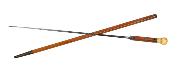 154. Ivory Sword Cane-Ca. 1810-An early ivory knob: 154. Ivory Sword Cane-Ca. 1810-An early ivory knob handle, various copper collars which have been silver plated, pair of original eyelets, 24” blade, malacca handle and shaft and a 3 ½’ brass fer