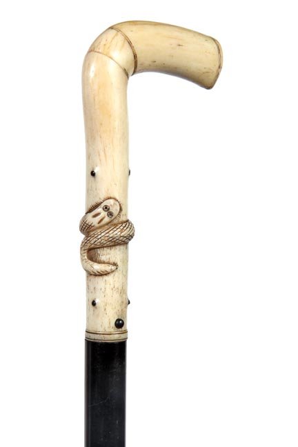 156. Early Sword Cane-Ca. 1860-An early bone handle: 156. Early Sword Cane-Ca. 1860-An early bone handle with a carved snake and assorted bone inlays, push button locking mechanism with a 13” four sided ornate blade, ebony shaft and a horn ferrule-H.