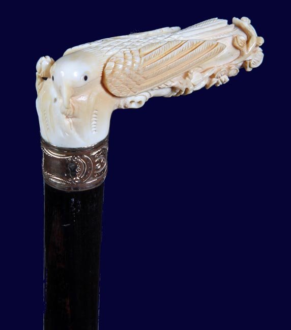 69. Ivory Exotic Bird Cane-Ca. 1920-A high relief: 69. Ivory Exotic Bird Cane-Ca. 1920-A high relief carving of a unique bird with horn eyes, very detailed carving, ornate gold-filled collar, thick ebony shaft and a metal ferrule-H. 4” x 1 ½”, O.