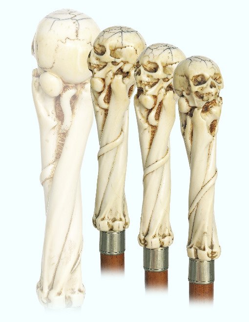 86. Ivory Memento Mori Cane-Ca. 1860-Straight handle: 86. Ivory Memento Mori Cane-Ca. 1860-Straight handle with a human skull on three longer femur bones, malacca shaft with a metal collar and an ivory ferrule.-H. 5 ¾” x 1 ¾”, O.L. 33 ¾”-