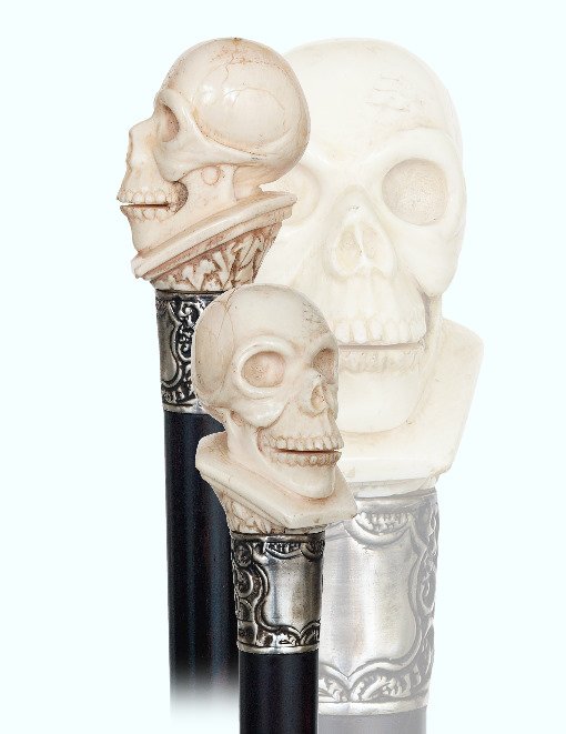 88. Ivory Skull Cane-Ca. 1880-Ivory human skull on a: 88. Ivory Skull Cane-Ca. 1880-Ivory human skull on a plinth with ivy, silver collar with Birmingham hallmarks, ebony shaft and a horn ferrule.-H.. 2 ½” x 1 ¾”, O.L. 38”-