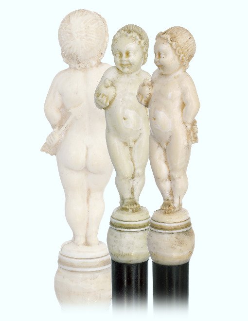 105. Ivory Cupid Cane-Ca. 1880-Straight figural ivory: 105. Ivory Cupid Cane-Ca. 1880-Straight figural ivory handle depicting Cupid the god of desire, erotic love, attraction and affection. Ebony shaft and a metal ferrule. -H. 3 ½” x 1”, O.L. 38 ½��