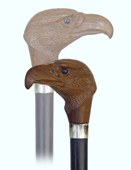 130. Eagle Head Day Cane-Ca. 1900-Rosewood eagle head: 130. Eagle Head Day Cane-Ca. 1900-Rosewood eagle head handle with a fine feather coat, strong curving beak and two inset glass eyes. Ebony shaft with a replaced metal ferrule and a plain silver collar