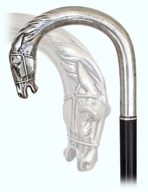 132. Silver Day Cane-Ca. 1900-Large silver crook handle: 132. Silver Day Cane-Ca. 1900-Large silver crook handle with a horse head at the front, ebony shaft and a metal ferrule. German 800 hallmark.-H. 5” x 4 ½”, O.L. 37”-