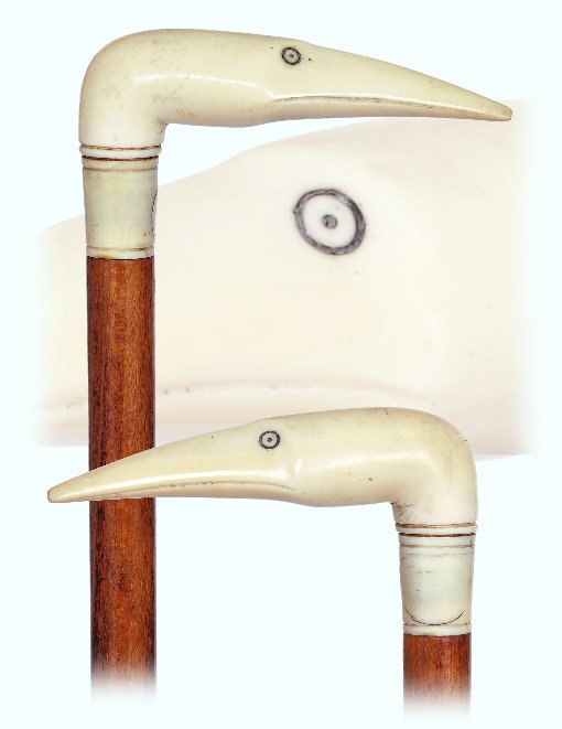 172. Knobkerrie Ivory Day Cane-Ca. 1900-L-shaped ivory: 172. Knobkerrie Ivory Day Cane-Ca. 1900-L-shaped ivory handle carved as a stylized bird’s head, polished beech wood shaft with a metal ferrule. -O.L. 37 ½”-