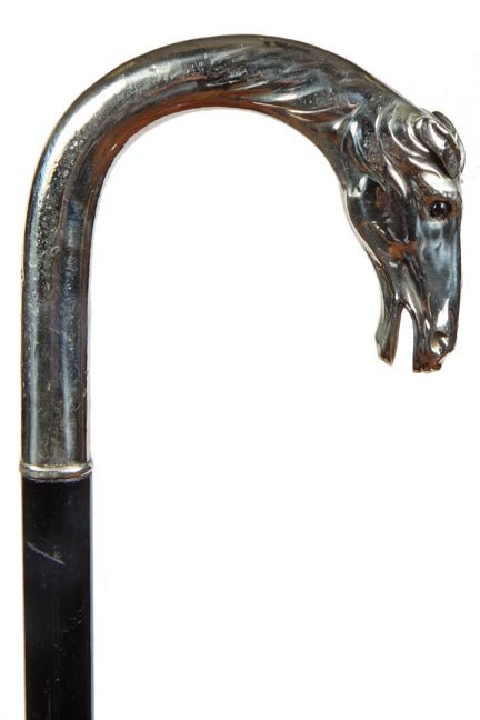 176. Silver Dress Cane-Ca. 1930-An Alpaca silver-plated: 176. Silver Dress Cane-Ca. 1930-An Alpaca silver-plated horse cane with two color glass eyes, ebony shaft and a metal ferrule-H. 4 ½” x 5”, O.L. 38”-