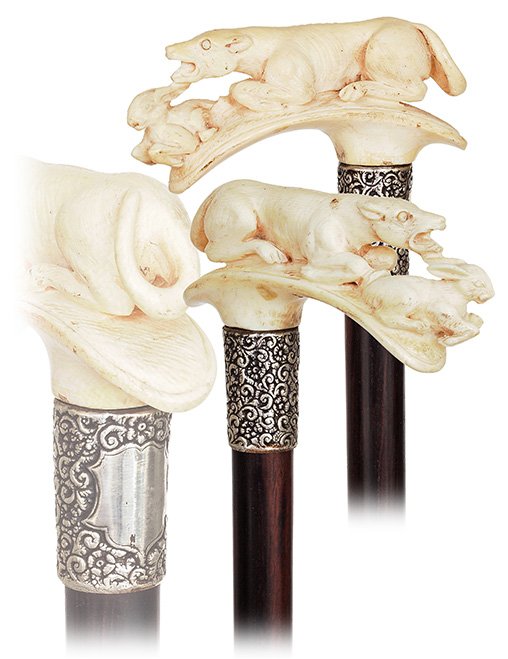 4. Ivory Dog and Hare cane-Early 1900s-Horizontal ivory: 4. Ivory Dog and Hare cane-Early 1900s-Horizontal ivory handle carved with a dog running after a hare, well chased silver collar, ebony shaft and a horn ferrule. -H. 4 ¼” x 36 ¾”, O.L. 37”-