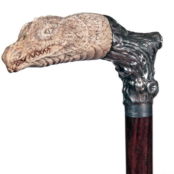 35. Stag Dragon Dress Cane-Early 20th Century-A carved: 35. Stag Dragon Dress Cane-Early 20th Century-A carved staghorn dragon of sorts, attached with a silver metal tree trunk, exotic wood shaft and a horn ferrule-H. 5 ¼” x 3 ¼”, O.L. 37”-