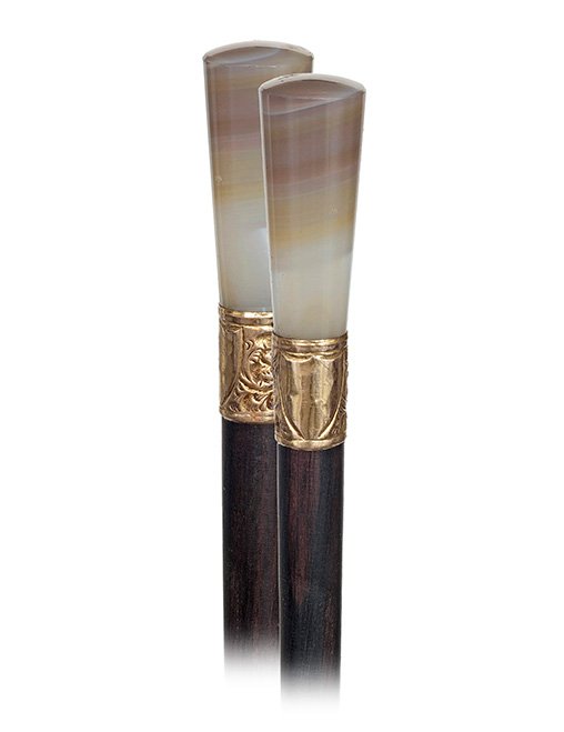 124. Hard Stone Dress Cane-Ca. 1890-Layered, grey agate: 124. Hard Stone Dress Cane-Ca. 1890-Layered, grey agate straight and fluting handle with a finely chased Victorian gold plated collar and a slender ebony shaft with a tiny metal ferrule.-H. 2 ½” x