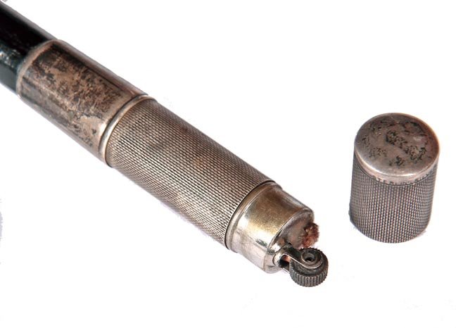 189. Cigarette Lighter Cane-Ca. 1925-An Art Deco: 189. Cigarette Lighter Cane-Ca. 1925-An Art Deco unmarked sterling cigarette lighter system cane, working condition, ebony shaft and a metal ferrule-H. 3” x 1 5/8”, O.L. 36”-