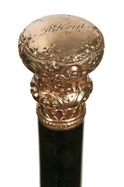 192. Gold Dress Cane-Ca. 1900-A signed Simmons ornate: 192. Gold Dress Cane-Ca. 1900-A signed Simmons ornate gold-filled handle, thick ebony shaft and a metal ferrule-H. 1 ½” x 1 ¾”, O.L. 32 ½”-