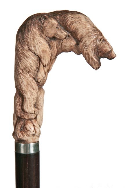 193. Staghorn Bear Cane-20th Century-A carved staghorn: 193. Staghorn Bear Cane-20th Century-A carved staghorn with three bears which are fishing for trout, nicely carved in high relief, silver metal collar, exotic wood shaft and a horn ferrule-H. 3 ¼”