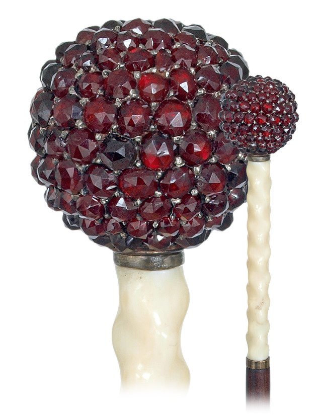 22. Ivory and Garnet Dress Cane-Ca. 1890-Straight ivory: 22. Ivory and Garnet Dress Cane-Ca. 1890-Straight ivory handle topped by a ball knob studded with individually set calibrated garnets, ebony shaft and a brass ferrule. Few hundred matching Bohemian Py