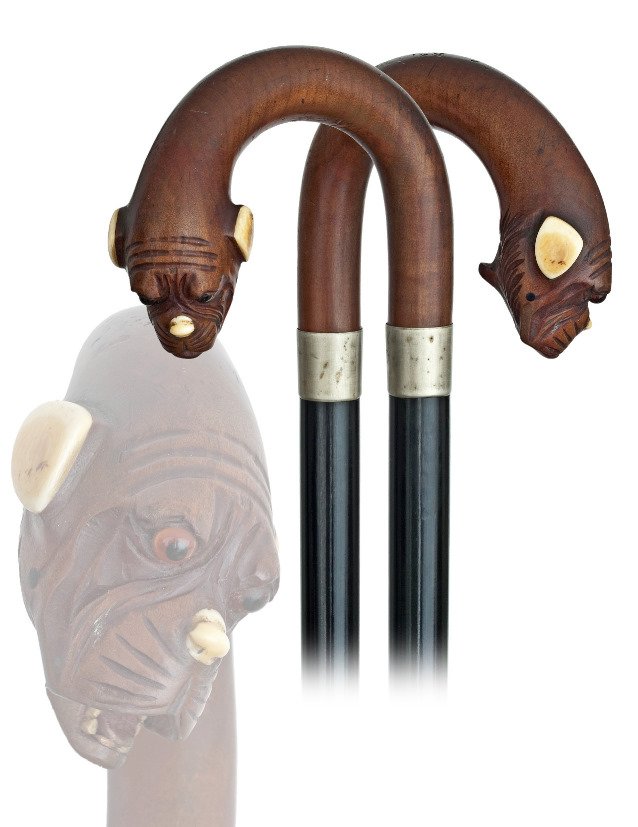 74. Articulated Dog Cane-Ca. 1880-Fruitwood crook: 74. Articulated Dog Cane-Ca. 1880-Fruitwood crook handle carved with a glove holder with ivory ears, glass eyes and push button lower jaw with sharp teeth and red tongue. Ebonized hardwood shaft with
