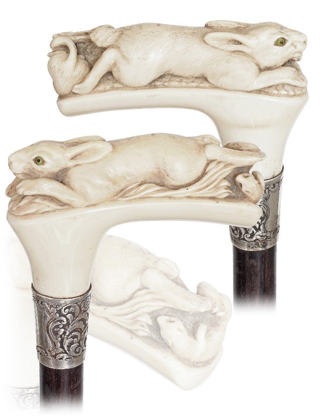 95. Ivory Rabbit Cane-Ca. 1890-Large ivory handle: 95. Ivory Rabbit Cane-Ca. 1890-Large ivory handle carved to depict a sweeping rabbit with inset glass eyes and a rodent between its back paws, ebony shaft and a horn ferrule. Very decorative English c