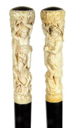 18. Adam and Eve Ivory Cane-20th Century-A high relief: 18. Adam and Eve Ivory Cane-20th Century-A high relief carving of the pair in the garden, ebony shaft and a horn ferrule-H. 4 ½” x 1 ¼”, O.L. 39”