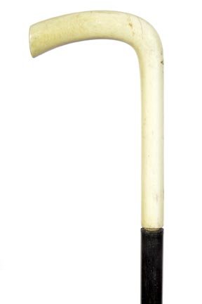 118. Ivory Dress Cane-Ca. 1900-A stylized and plain: 118. Ivory Dress Cane-Ca. 1900-A stylized and plain ivory handle, no collar, ebony shaft and a horn ferrule-H. 3 ¼” x 5 ¼”, O.L. 32”