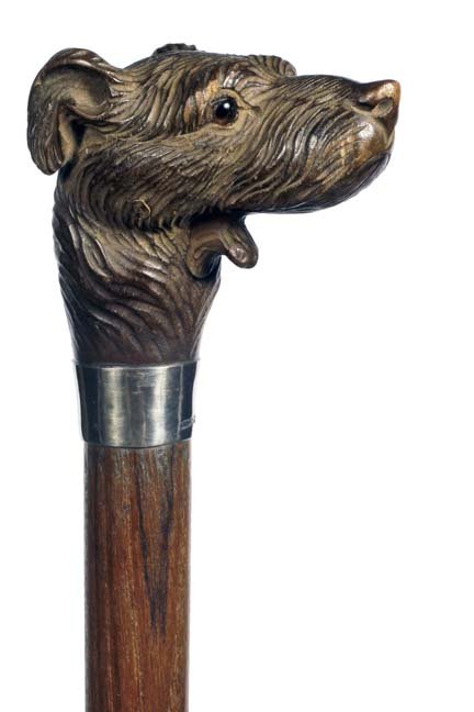 3. Dog Glove Holder Dress Cane - 1930- A well carved: 3. Dog Glove Holder Dress Cane - 1930- A well carved dog with two color glass eyes, signed sterling collar, push button lower jaw, hardwood shaft and metal ferrule. H 2 ¾” x 2”, O.L.- 36”