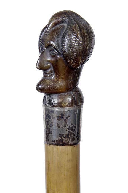 85. Abraham Lincoln Cane- Ca. 1900-A molded handle,: 85. Abraham Lincoln Cane- Ca. 1900-A molded handle, probably gutta percha, silver metal collar signed solid silver, malacca shaft and a 3” horn ferrule- H. 1 /12” x 2”, O.L.- 34”