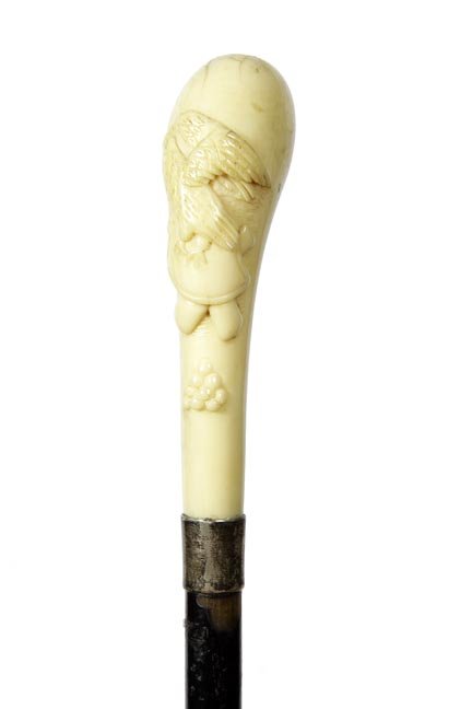 138. Ivory Eagle Dress Cane- Ca. 1875-A nice hunk of: 138. Ivory Eagle Dress Cane- Ca. 1875-A nice hunk of ivory with an eagle carved in high relief above cannons and cannon balls, silver metal collar, ebonized shaft and a metal ferrule-H. 4 ¾” x 2 �