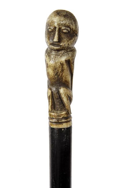 181. Inuit Bone Cane-Ca. 1935-A carved bone Inuit: 181. Inuit Bone Cane-Ca. 1935-A carved bone Inuit handle, ebonized malacca shaft and a metal ferrule-H. 4” x 1 ½”, O.L. 37 ½’
