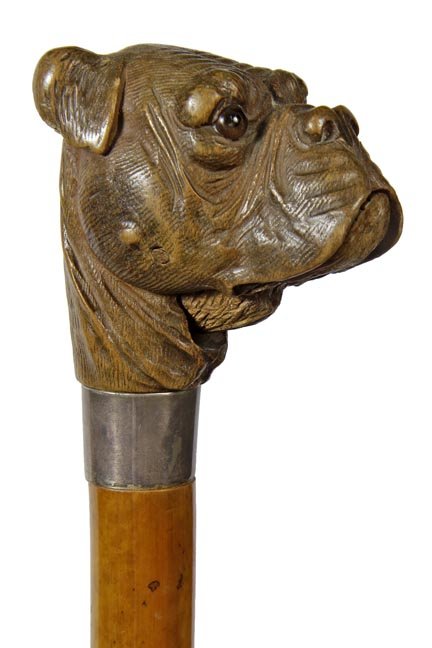 203. Large Carved Glove Holder Cane-C. 1885-A large and: 203. Large Carved Glove Holder Cane-C. 1885-A large and nicely carved walnut bulldog with two color glass eyes, spring loaded push lower jaw, silver metal collar, thick malacca shaft and a brass ferru