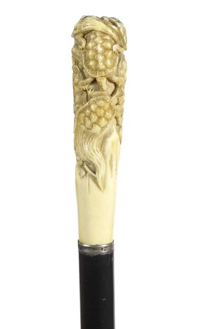 5. Japanese Ivory Turtle Cane- Ca. 1890-A large ivory: 5. Japanese Ivory Turtle Cane- Ca. 1890-A large ivory handle with a nest of turtles, silver collar, thick ebony shaft and a metal ferrule. H. 1 ½” x 5”, O.L.-35 ½”