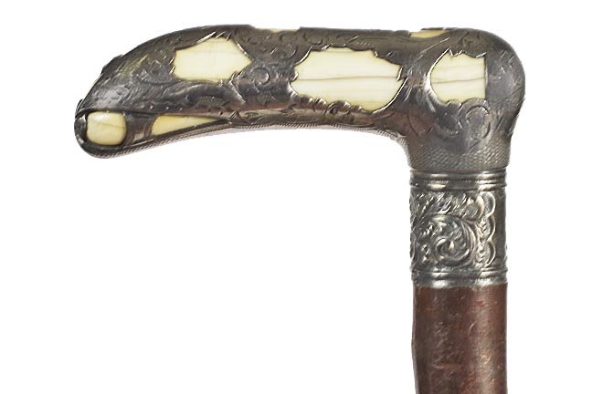 8. Art Nouveau Dress Cane- Ca. 1890-A silver over ivory: 8. Art Nouveau Dress Cane- Ca. 1890-A silver over ivory handle, ornate silver collar, full bark twig spur shaft and a metal ferrule. H. 4 ¼ x 1 ½”, O.L.35 ¼”