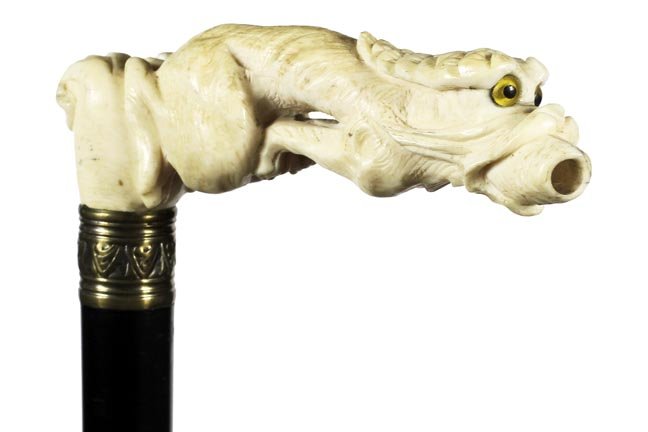 81. Chinese Ivory Dragon Cane- Ca. 1890-A carved ivory: 81. Chinese Ivory Dragon Cane- Ca. 1890-A carved ivory dragon with two color glass eyes, probably a cheroot holder, ornate brass collar, ebony shaft and a horn ferrule. H. 5” x 1 ½”, O.L. 35