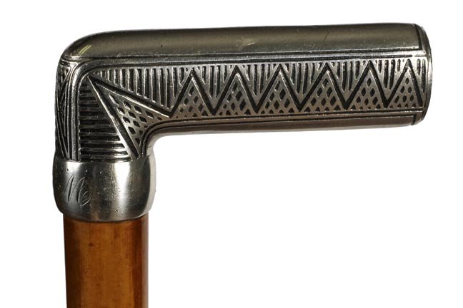 101. Tiffany Art Deco Dress Cane- Ca. 1920-: 101.Tiffany Art Deco Dress Cane- Ca. 1920-An Art Deco silver handle inscribed silver collar, malacca shaft and a horn ferrule. H. 4” x 2”, O.L.-34 ¾”