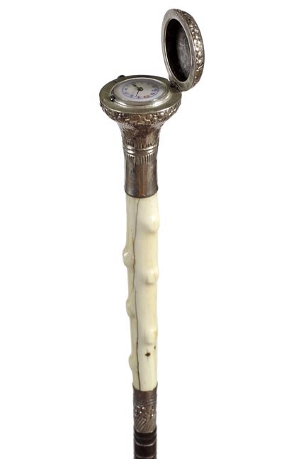 135. Silver Watch and Ivory System Cane- Ca. 1885-An: 135. Silver Watch and Ivory System Cane- Ca. 1885-An early compartment cane which houses a painted porcelain watch, twig spur ivory spacer, ornate silver collar, exotic wood shaft and a metal ferrule