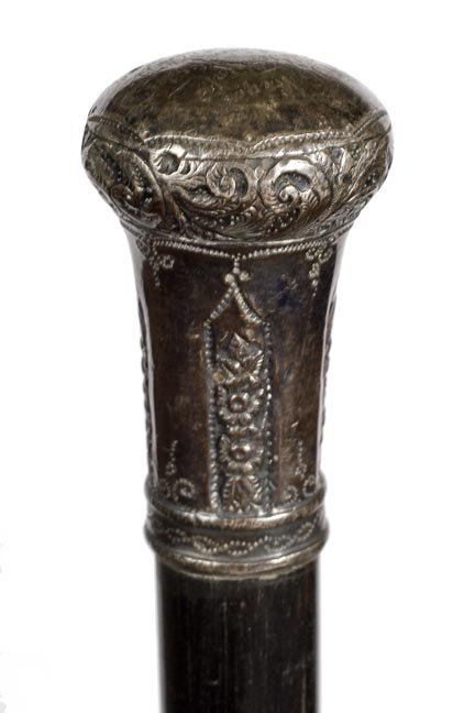 180. Silver Dress Cane - Ca. 1875- A weighted defensive: 180. Silver Dress Cane - Ca. 1875- A weighted defensive ornate silver-plated handle with a German presentation, thick ebony shaft and a metal ferrule. H. 1 ½” x 2 ½”, O.L.-35 ½”