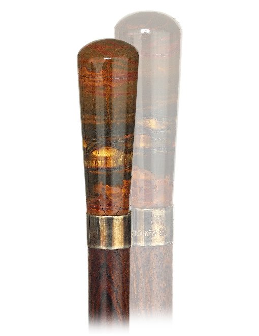 82. Hard Stone Dress Cane-Ca. 1920-A sizeable tiger eye: 82. Hard Stone Dress Cane-Ca. 1920-A sizeable tiger eye knob fashioned in an elongated, plain and tapering Milord shape, rosewood shaft with a stag horn ferrule and a plain silver collar struck Birmin