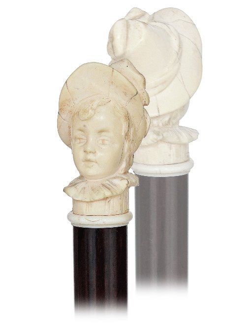 86. Ivory Portrait Cane -Ca. 1880-A well carved girl’s: 86. Ivory Portrait Cane -Ca. 1880-A well carved girl’s head with a frilled collar and large hat, turned ivory collar, rosewood shaft and a stag horn ferrule. The portrait not just to represent the p