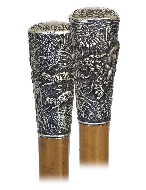 97. Silver Dress Cane-Ca. 1870-Substantial Milord Knob: 97. Silver Dress Cane-Ca. 1870-Substantial Milord Knob hand chased and engraved with a lion hunting three sheep on a background with large leafage. Malacca shaft, round silver eyelets and a horn ferru