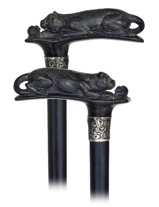 112. Horn Cat and Mouse Cane-Early 1900s-Horizontal: 112. Horn Cat and Mouse Cane-Early 1900s-Horizontal black horn handle carved with a cat and a mouse, chased silver collar, glass eyes ebony shaft and a horn ferrule. -H. 4 ¼” x 36 ¾”, O.L. 37”