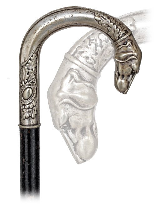 134. Dog Day Cane-Ca. 1910-Large silver plated white: 134. Dog Day Cane-Ca. 1910-Large silver plated white metal crook handle modeled with a pointer head and oak leaves. It is personalized with the engraved name of its first owner “Richard Lorenz” an