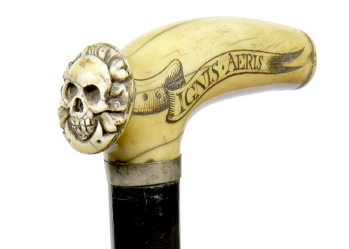 40. Ivory Skull Cane- Early 20th Century-A unique: 40. Ivory Skull Cane- Early 20th Century-A unique carved skull thumb rest “Aqvea-terrae-ignis-aeris”, silver metal collar, ebony shaft and a horn ferrule-H. 4” x 1 ½”, O.L. 34”