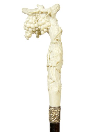 80. Ivory Wildlife Cane- Ca. 1890-A carved ivory handle: 80. Ivory Wildlife Cane- Ca. 1890-A carved ivory handle with grapes and vine, ornate rose gold-filled collar, ebony shaft and a horn ferrule-H. 1 ¾” x 4 ¾”, O.L. 35 ½”