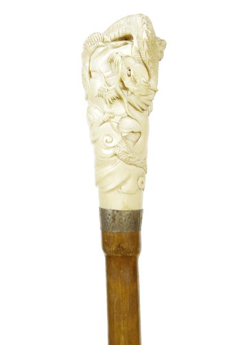 230.Ivory Dragon Cane- Ca.1890-A fully carved dragon: 230.Ivory Dragon Cane- Ca.1890-A fully carved dragon handle with a pair of these fierce creatures, silver metal collar bamboo shaft and a horn ferrule, H.4”x1 ½ “,O.L.33 ½ “